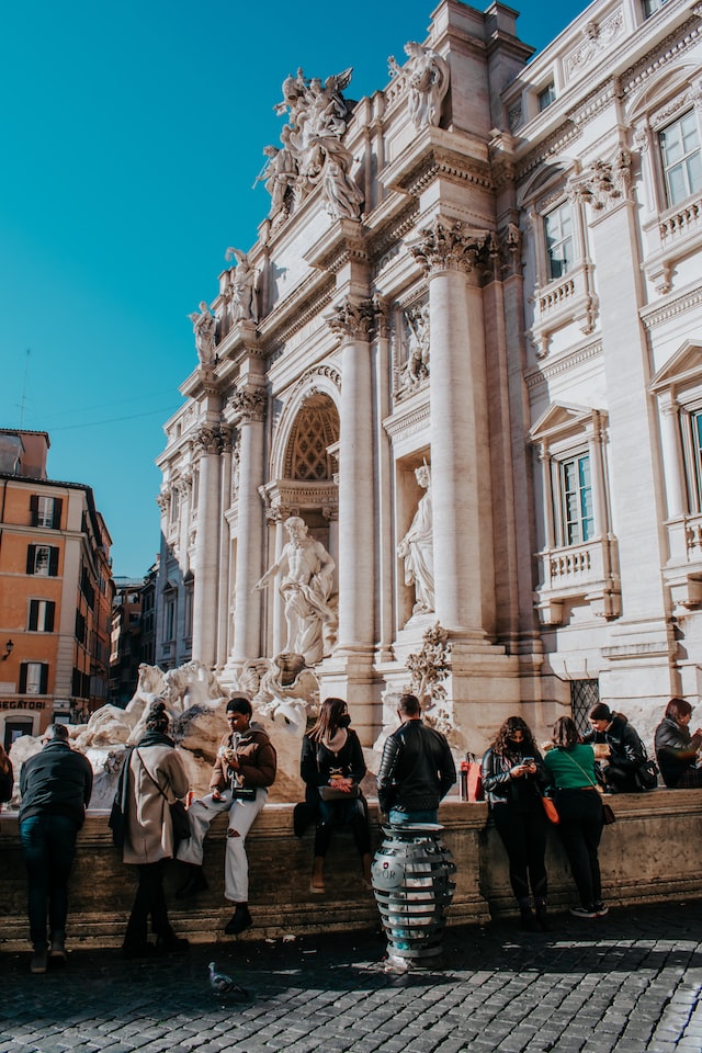 Group of people standing near the Trevi fountain