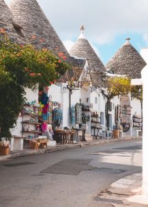 I trulli, dry stone huts with conical roofs, decorated colorfully.