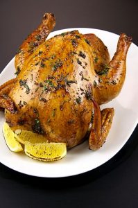 Roasted chicken with herbs and lemons.