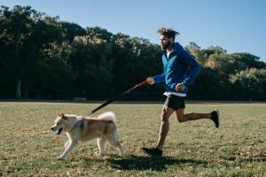 Person running with a dog.