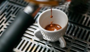 Coffee drink being made in an espresso cup