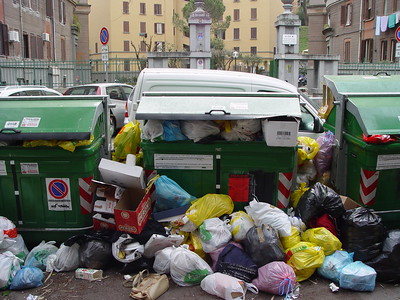 Three trash bins full of garbage in Rome