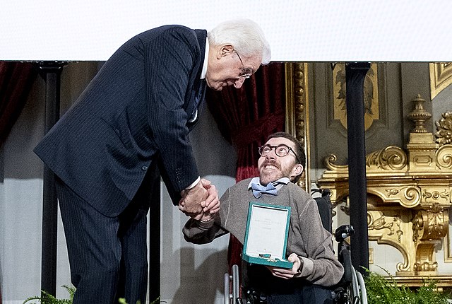 Italian activist Iacopo Melio receiving a prize by the President of Italy
