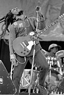 A picture of Bob Marley playing his guitar