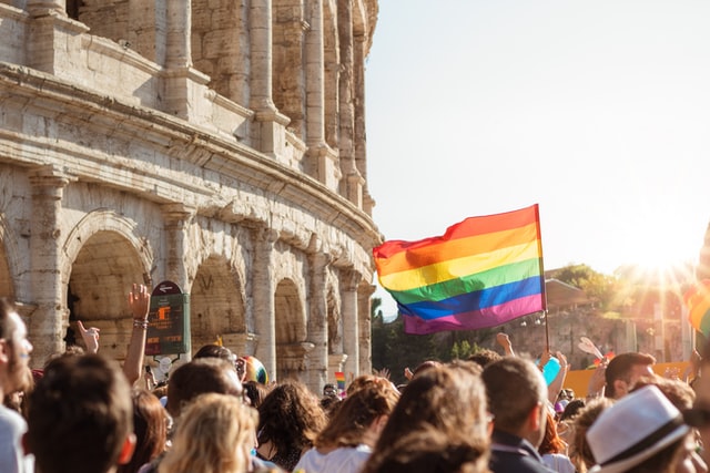 Gay pride in Rome; people protesting with the Colosseum in the background