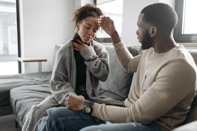 A man checking the fever in a woman