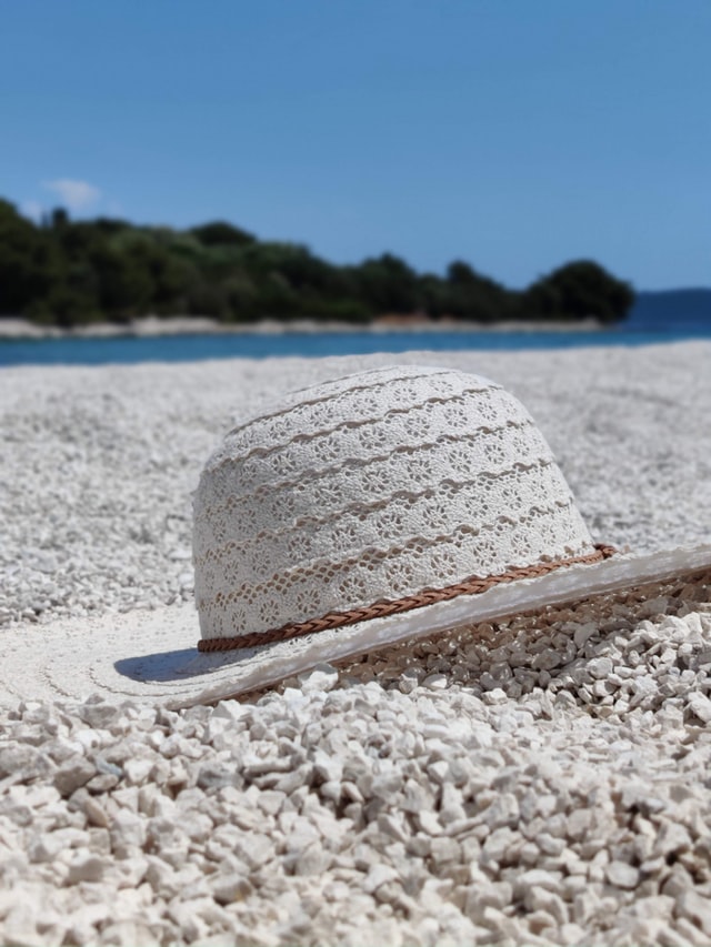 Large, white sun hat on a beach