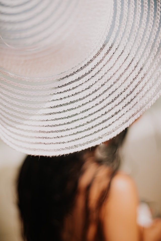 Person wearing a large, white sun hat