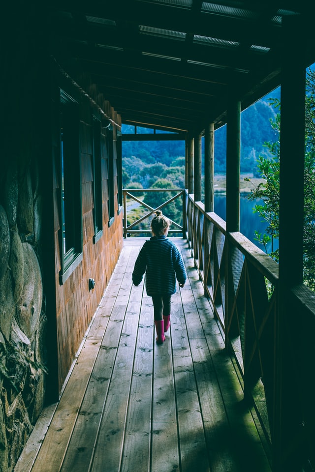 Person walking wearing a coat and pants