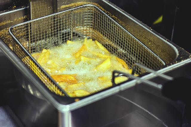 Potatoes being deep fried in oil