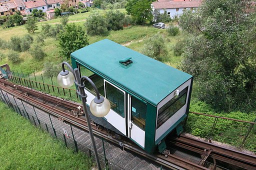 white and green train up the hill