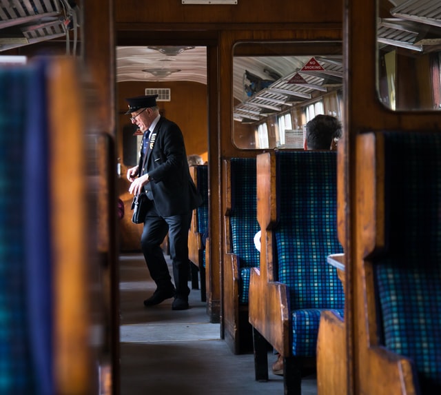 A train conductor checking tickets