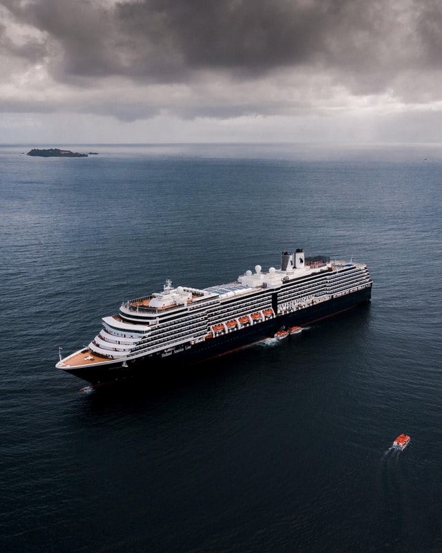 A white and black cruise ship sailing on sea