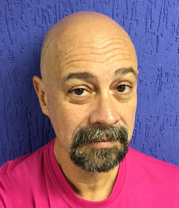 Bald person with facial hair