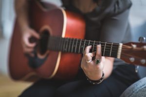 Person playing acoustic guitar