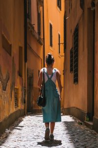 Person walking on a cobblestone street