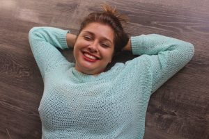 Smiling person lying on the ground