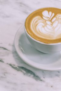 Cappuccino in a white cup and saucer.