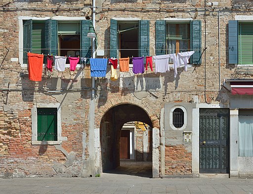 Old house with windows, door, arch walkthrough, and clothesline