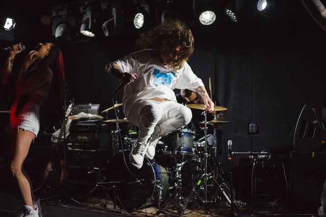 A singer jumping on a stage