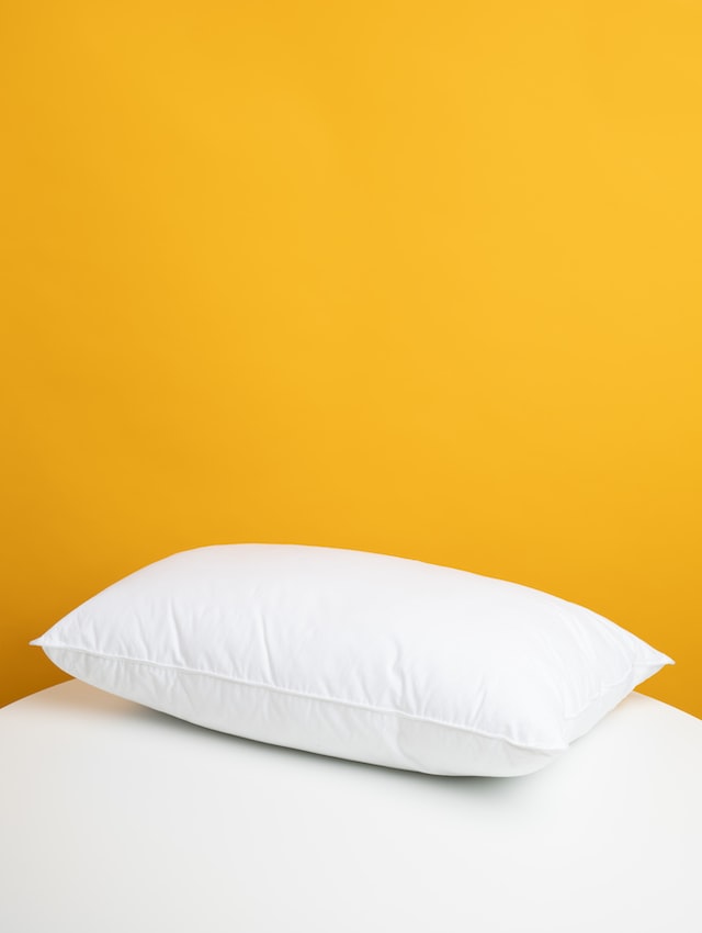 White pillow on a white bed