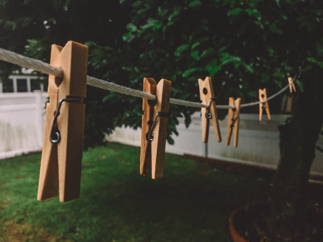 Clothespins hanging on rope outside a house