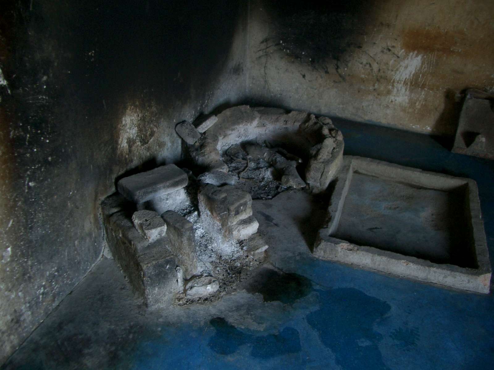 Several items of stone cookware in the corner of a kitchen.