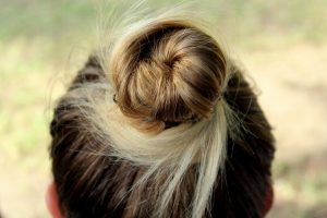 Brown/blonde hair in a bun