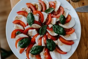 Plated spiral of tomato, mozzarella, and basil