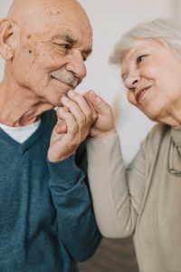 Old couple holding hands